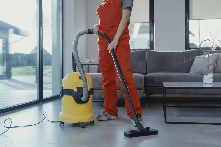 Asian couple having fun while cleaning their home, enhancing a cheerful atmosphere.